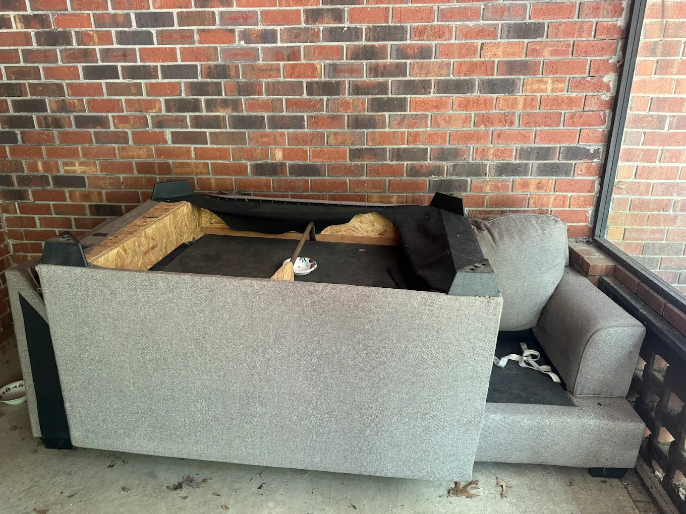 Old sofa being broken down for hauling